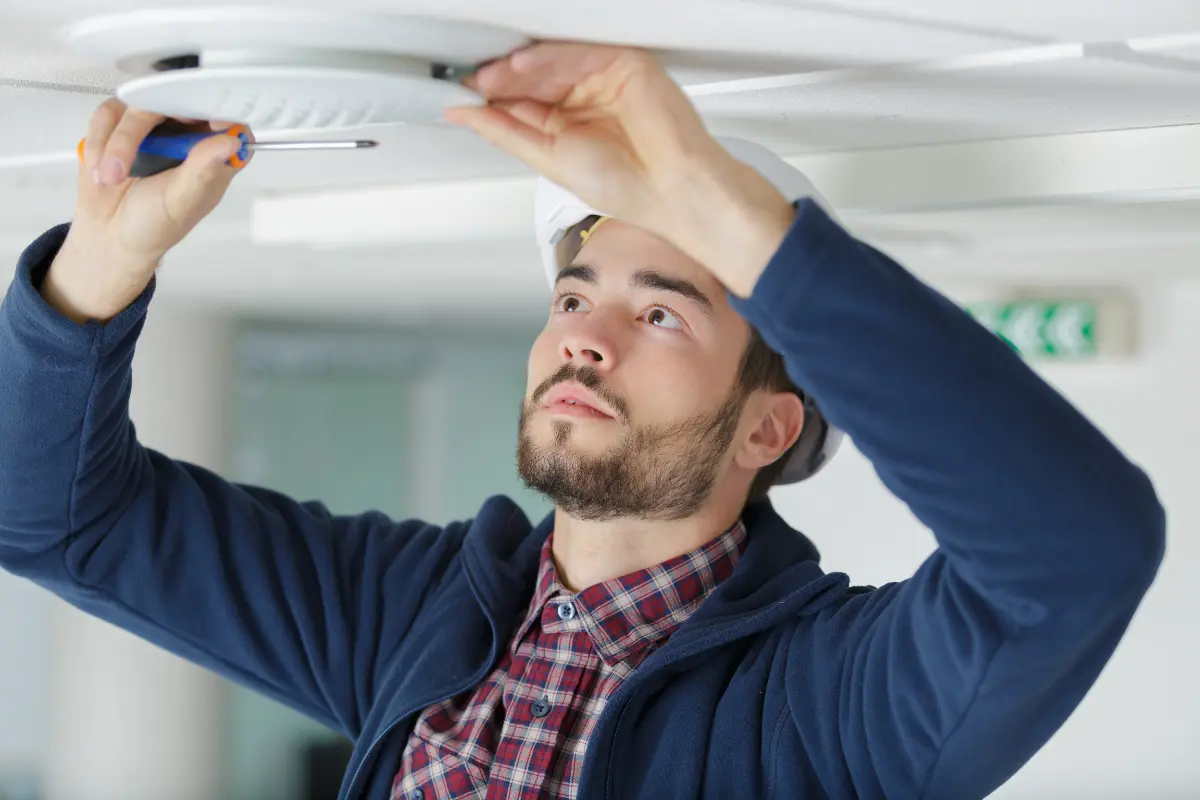 electrician installing ceiling light